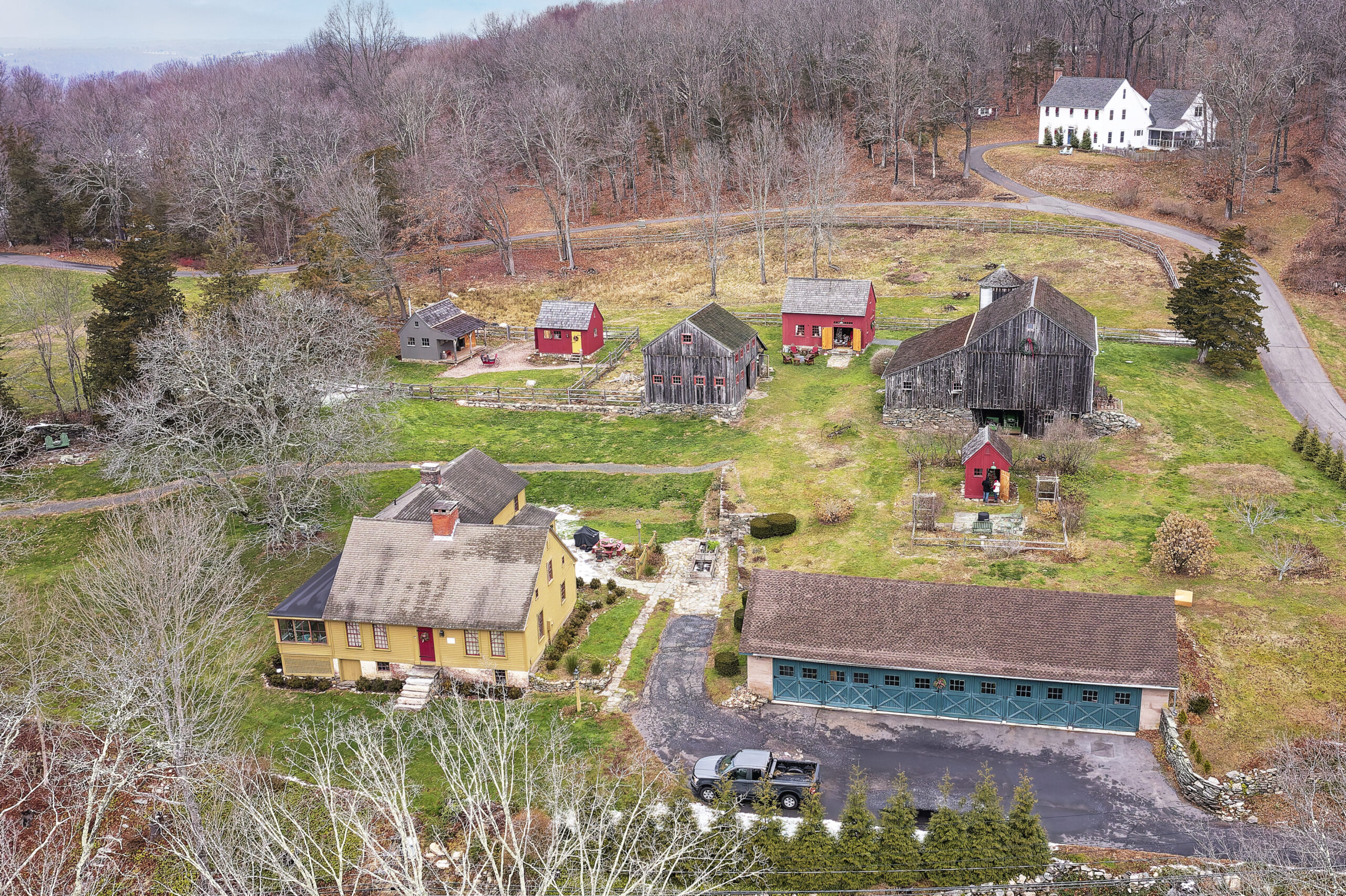 Drone shot of a farm in Connecticut with four different Post and Beam Barns on it.