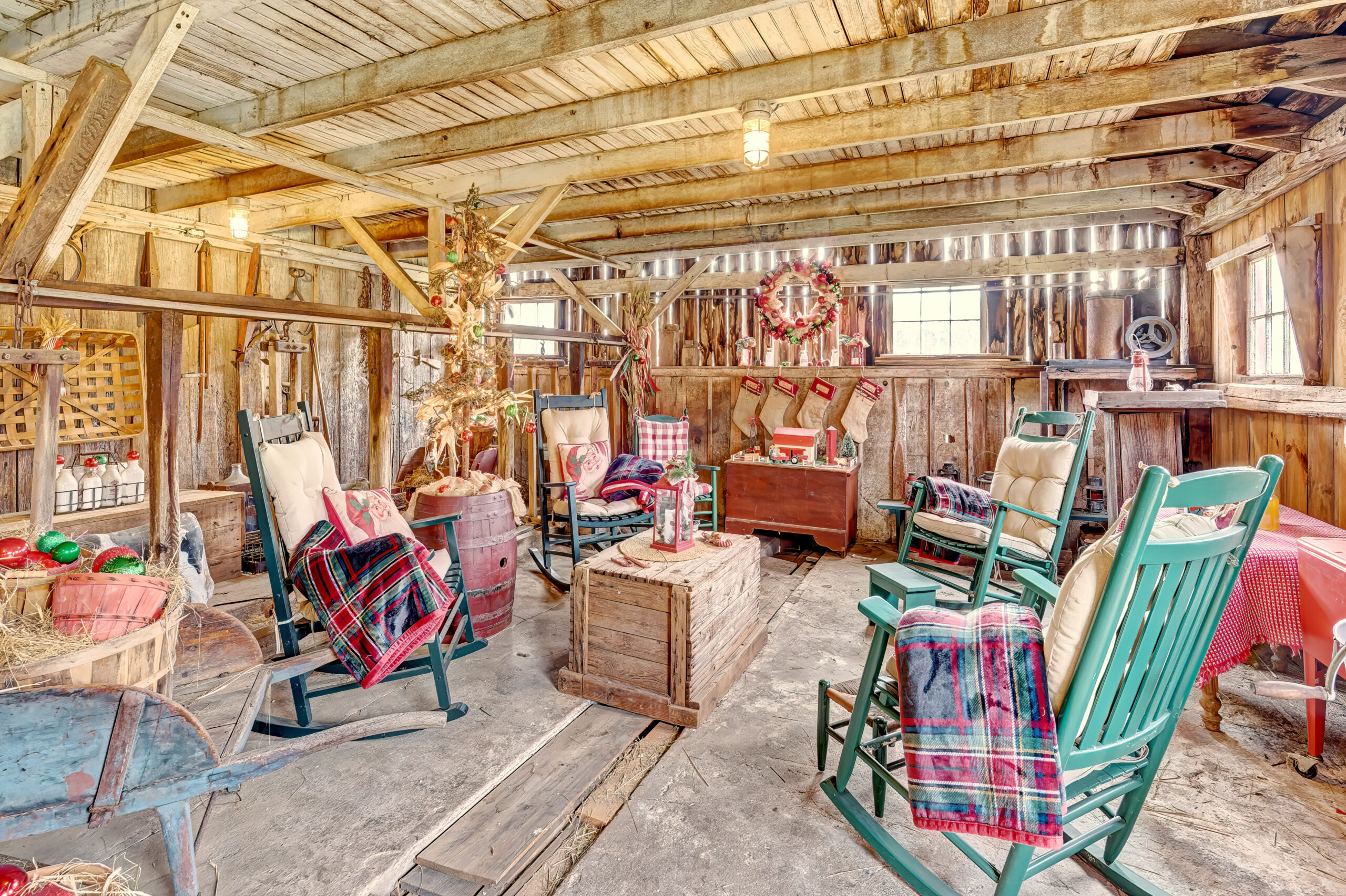 Interior view of a vintage barn that is decorated for Christmas.